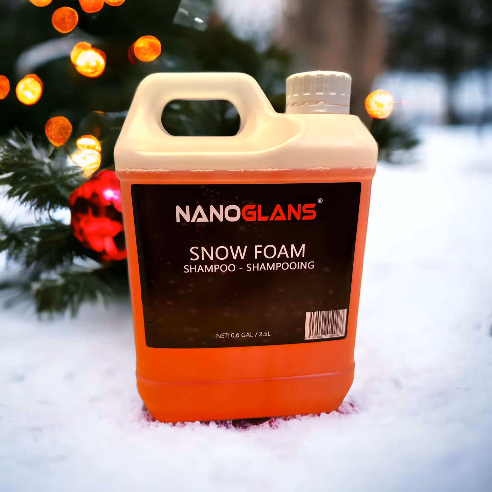 Snow Foam Shampoo bottle in snow near Christmas tree